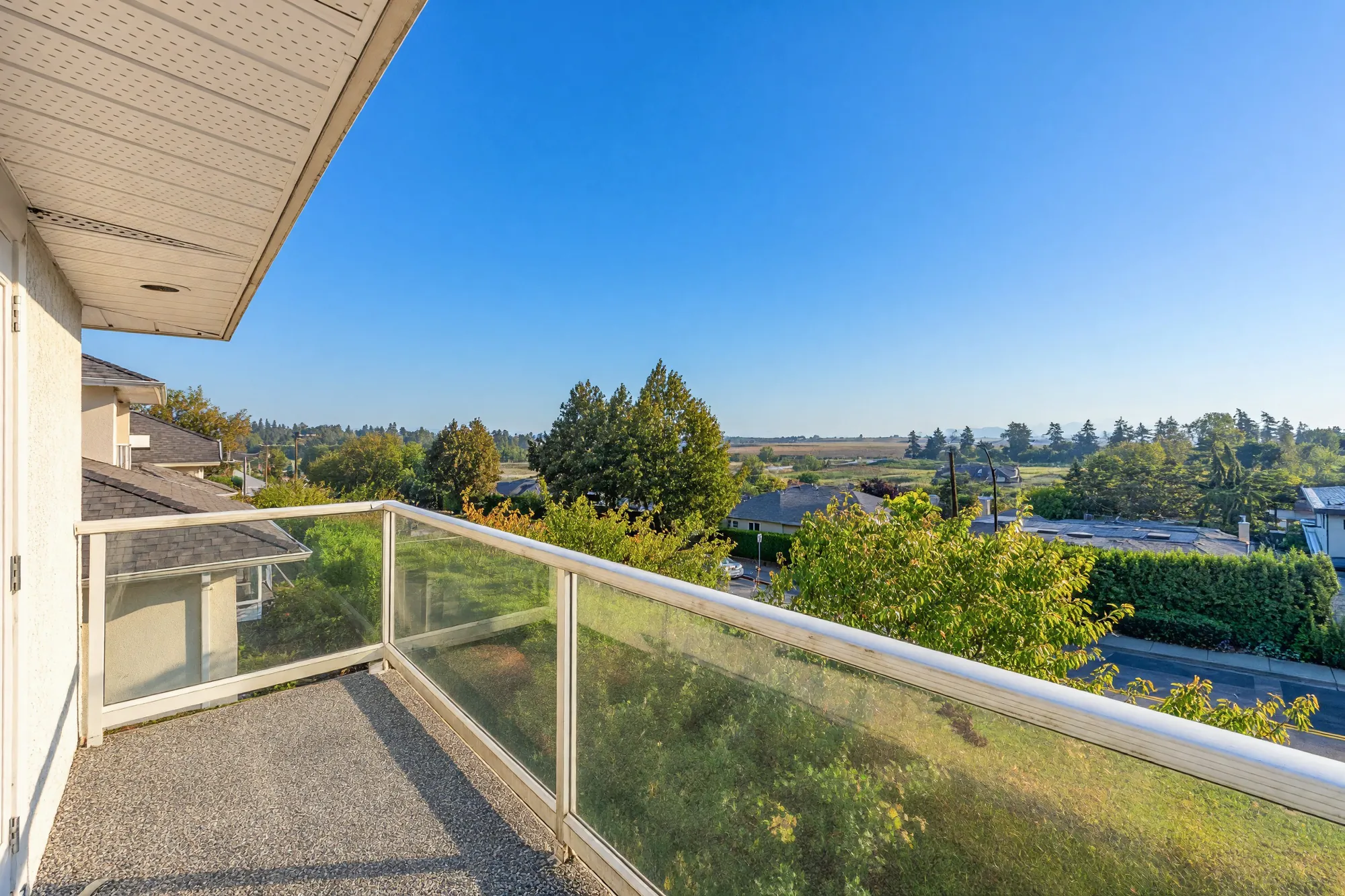 Along the upper balcony toward the farmland, a gable at the left