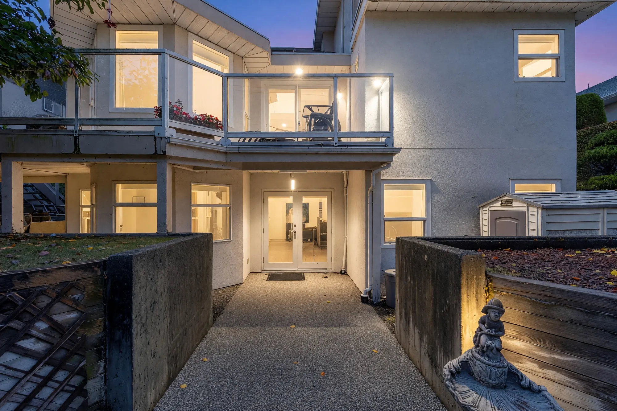 The same view at dusk, the windows and the doors lit